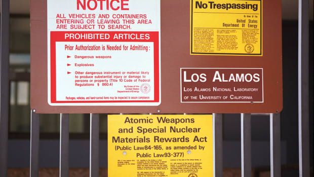 Signs are posted on the gated wall around the main technical area of Los Alamos National Laboratory in New Mexico.