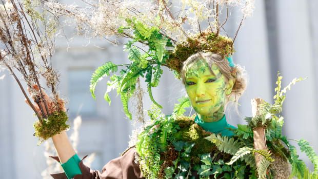 A woman dressed as a tree poses after marching at Rise for Climate in San Francisco on September 8th, 2018.