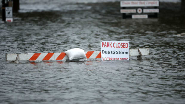A sign warns people away from Union Point Park after it was flooded by the Neuse River during Hurricane Florence on September 13th, 2018 in New Bern, North Carolina.