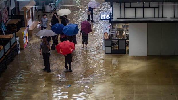 People walk through a flooded shopping mall in the Heng Fa Chuen district during Typhoon Mangkhut in Hong Kong, China, on September 16th, 2018.