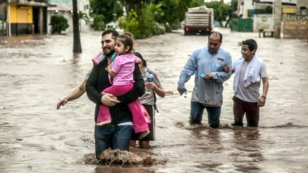 People wade through a flooded street in the city of Culiacán, in Sinaloa State, Mexico, on September 20th, 2018. Heavy rains flooded many of Culiacán's neighborhoods in just a few hours.