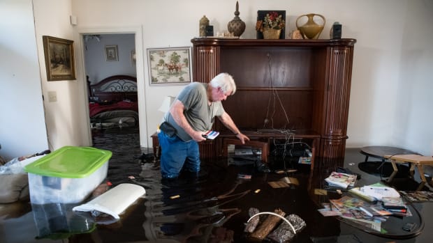 Billy Hardee removes valuables from his home as floodwater from Hurricane Florence rises at Aberdeen Country Club on September 20th, 2018, in Longs, South Carolina.