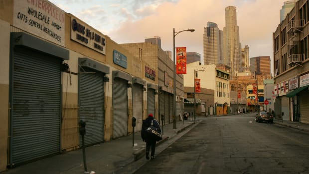 A homeless man walks down the street in the downtown Skid Row area of Los Angeles, California.
