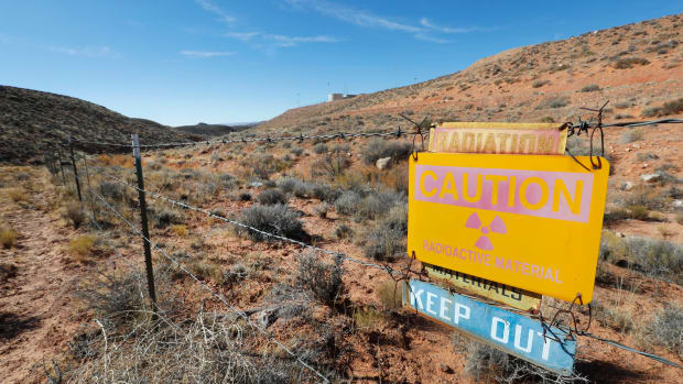 A radioactive warning sign hangs on fencing around the Anfield's Shootaring Canyon Uranium Mill on October 27th, 2017, outside Ticaboo, Utah.
