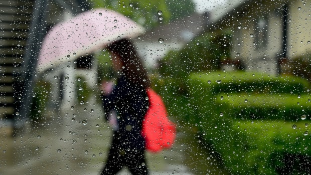 A pedestrian uses her umbrella in the rain in Alhambra, California, on April 8th, 2016.