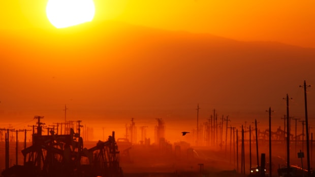 The sun rises over an oil field in Lost Hills, California, on March 24th, 2014.