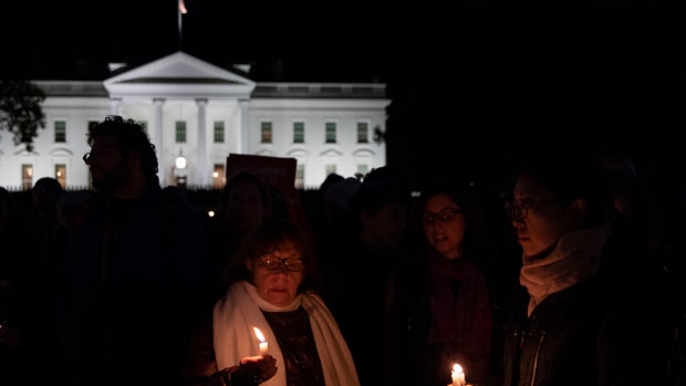 Vigil participants hold candles and sing a Jewish prayer in front of the White House on October 27th, 2018, during a vigil for the victims of the Tree of Life Congregation shooting.