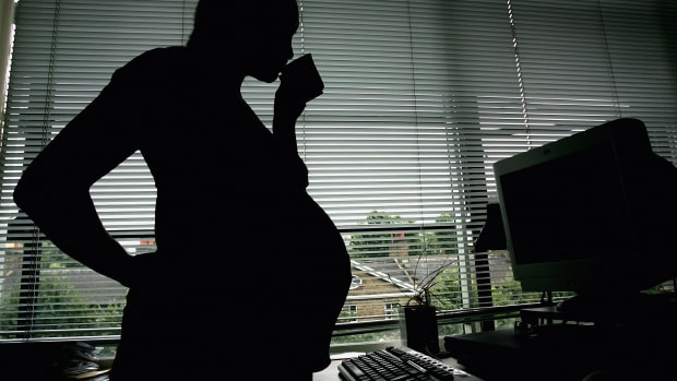 A woman is seen stood at her office work station on July 18th, 2005, in London, England.