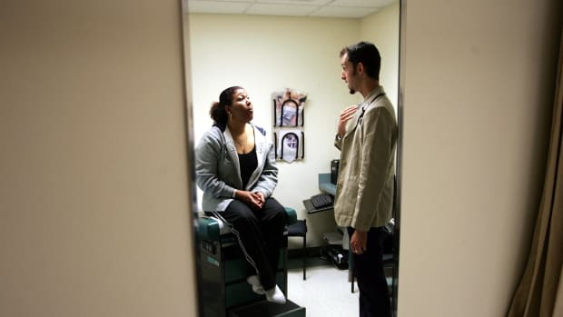 Dr. Ethan Brackett listens during an examination of patient Cristina Valdez at the Codman Square Health Center on April 11th, 2006, in Dorchester, Massachusetts.