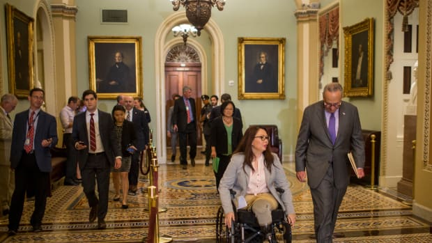 Senator Tammy Duckworth and Senate Minority Leader Chuck Schumer head to a weekly news conference on Capitol Hill in Washington, D.C., on August 21st, 2018.