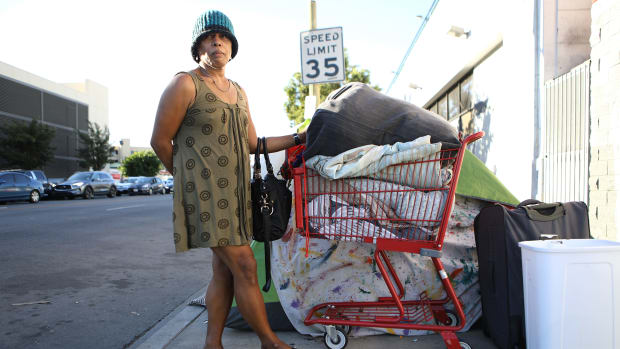An unnamed homeless woman poses with her belongings on November 2nd, 2018, in Los Angeles, California.