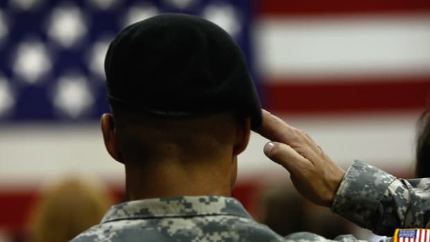 A U.S. Army soldier salutes during the national anthem as soldiers return home from Iraq on August 29th, 2009, in Fort Carson, Colorado.
