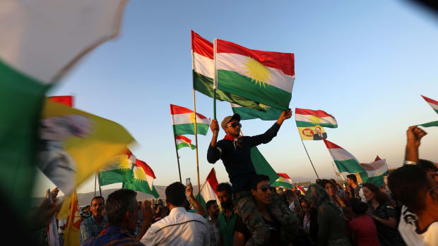 Syrian Kurds wave the Kurdish flag in the Syrian city of Qamishli on September 27th, 2017, during a gathering in support of the independence referendum in Iraq's northern Kurdish region.