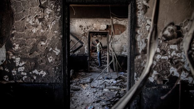Benghazi, Libya: On the outskirts of the city, a man stands in a government building that was burned by the opposition in February of 2011, at the beginning of a revolution against the 41-year regime of Muammar Gaddafi.