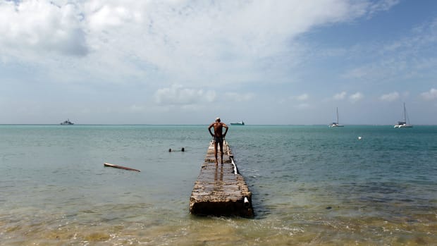 A man stands on a damage pier days after this Caribbean island sustained extensive damage in the wake of Hurricane Irma on September 15th, 2017, in St. Martin.