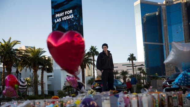 Matthew Helms, who worked as a medic the night of the shooting, visits a makeshift memorial for the victims of Sunday night's mass shooting on the north end of the Las Vegas Strip on October 3rd, 2017, in Las Vegas, Nevada.