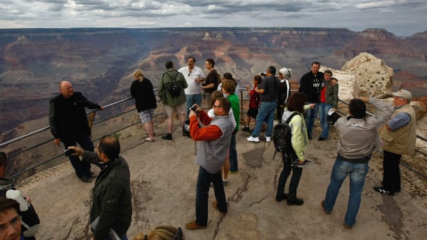 Tourists snap photos at Mather Point in the Grand Canyon National Park, Arizona.