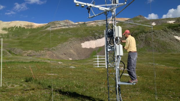 Mountain researcher Chris Landry, former director of the Colorado Center for Snow and Avalanche Studies, checks climate measuring instruments at a research station at 11,000 feet elevation in the San Juan Mountains of Colorado.