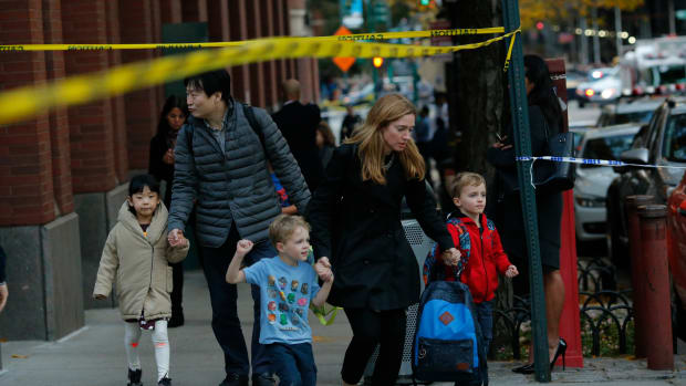 Children are evacuated from a school as emergency personal respond after a man driving a rental truck struck and killed eight people on a jogging and bike path in Lower Manhattan on October 31st, 2017, in New York City.