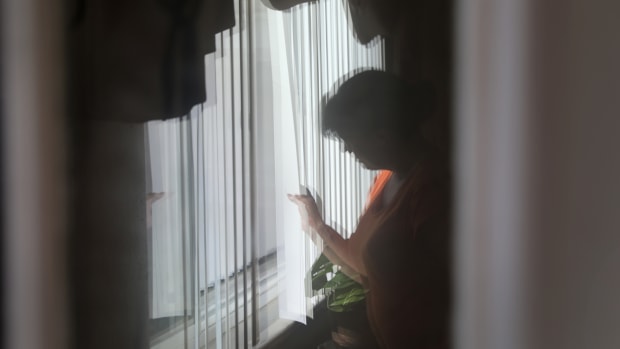 An undocumented Mexican immigrant looks out from her home on June 7th, 2017, in Denver, Colorado.