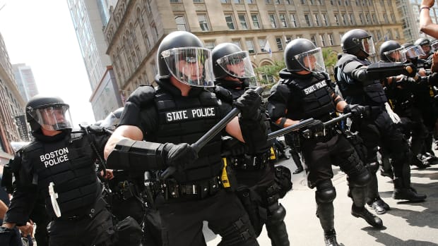 Protesters face off with riot police escorting conservative activists following a march in Boston against a planned "Free Speech Rally" just one week after the violent "Unite the Right" rally in Virginia left one woman dead and dozens more injured.