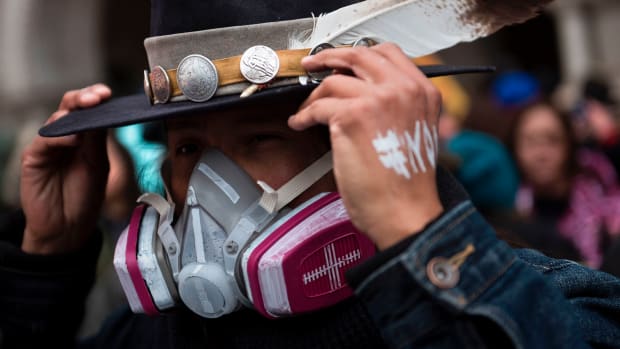 An activist adjusts his hat while protesting the Keystone XL Pipeline during the Native Nations Rise protest on March 10th, 2017, in Washington, D.C.