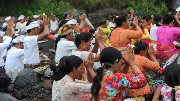 Balinese Hindus take part in a ceremony, where they pray near Mount Agung in hope of preventing a volcanic eruption, in Muntig village of the Kubu sub-district in Karangasem Regency on Indonesia's resort island of Bali on November 26th, 2017.