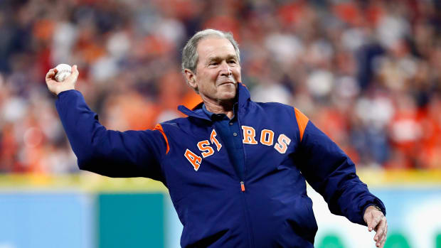 George W. Bush throws out the ceremonial first pitch before game five of the 2017 World Series on October 29th, 2017, in Houston, Texas.