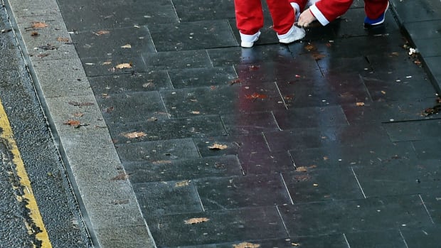 Runners dressed in Father Christmas costumes arrive to take part in the annual five kilometer Santa Dash in Liverpool, England, on December 3rd, 2017. Many runners wear a blue suit, usually the supporters of Everton football club, rather than a red one, as red is the color of their bitter rivals, the Liverpool football club.