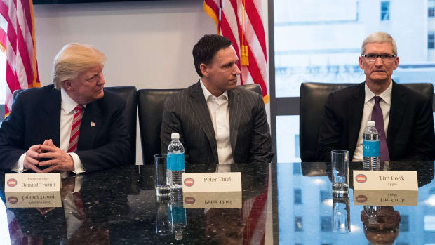 A photo of Donald Trump, Peter Thiel, and Tim Cook.