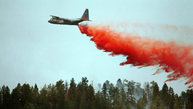 A slurry bomber drops its load on a ridge in an effort to stop the Hayman Fire on June 14th, 2002, in Deckers, Colorado.