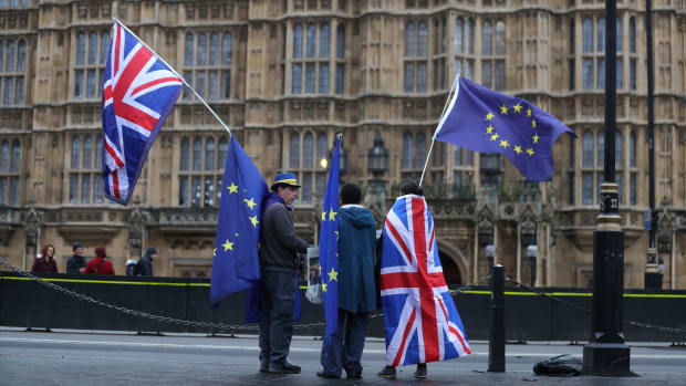Pro-European Union, anti-Brexit demonstrators hold Union and E.U. flags outside the Houses of Parliament in London on December 21st, 2017.