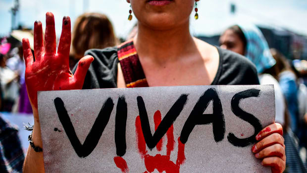A Mexican woman holding a sign reading "We want us alive" takes part in a protest against murders and other violence toward women in Mexico City on September 17th, 2017.