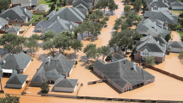 Homes are surrounded by floodwater after torrential rains pounded Southeast Texas.