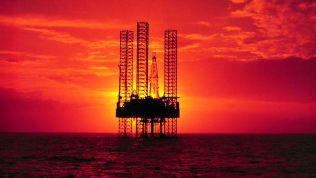 Pennzenergy Company Oil Exploration Drilling Rig in the Gulf of Mexico during sunset.