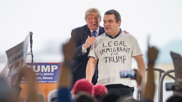 Donald Trump pulls a supporter from a crowd at a rally on March 13th, 2016, in Bloomington, Illinois.