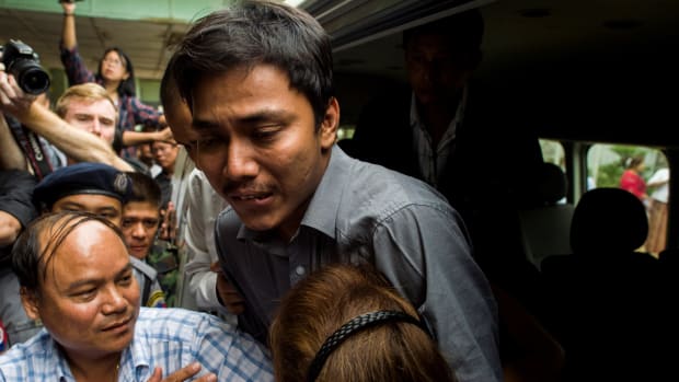Kyaw Soe Oo, a journalist for the Reuters newswire, hugs his sister upon his arrival at a court in Yangon on December 27th, 2017.