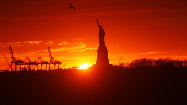 The Statue of Liberty stands in New York Harbor at sunset on January 23rd, 2018, in New York City.