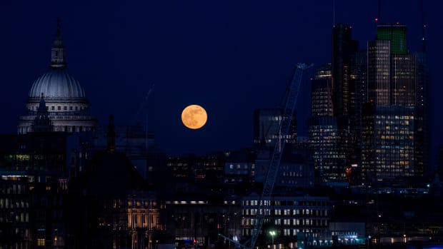 A supermoon rises behind St. Paul's Cathedral and skyscrapers on January 31st, 2018, in London, United Kingdom. The Super Blue Blood Moon is a rare simultaneous combination of a supermoon, a blood moon, and a blue moon.