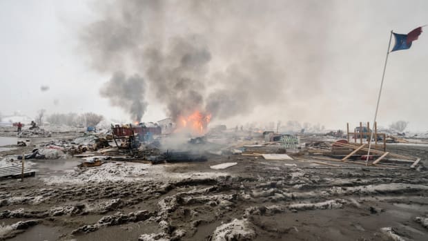 Activists departing the Dakota Access Pipeline protests burn their tents. Next month, we return to Standing Rock one year after the demonstrations.