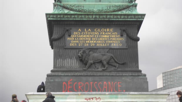 Pro-degrowth graffiti on the July Column in the Place de la Bastille in Paris during a protest against the First Employment Contract, on March 28th, 2006.