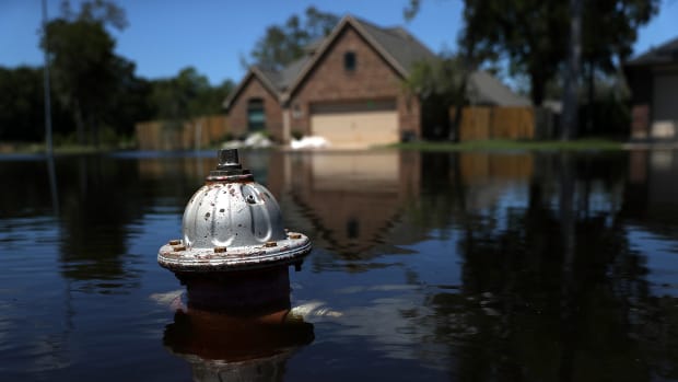 The top of a fire hydrant sticks out of floodwaters in front of a home on September 7th, 2017, in Richwood, Texas.
