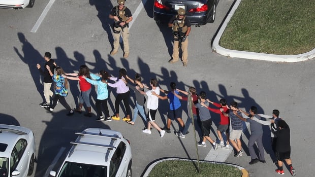 People are brought out of the Marjory Stoneman Douglas High School after a shooting on February 14th, 2018, in Parkland, Florida.