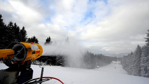 A snow cannon blowing snow onto a ski slope.