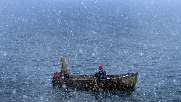 Fishermen row through heavy snowfall as they return to the shores of Lake Ohrid in Pogradec, Albania, on February 27th, 2018. Heavy snow and low temperatures have hit the Balkan countries, including Albania, causing problems for the traffic and power supply.