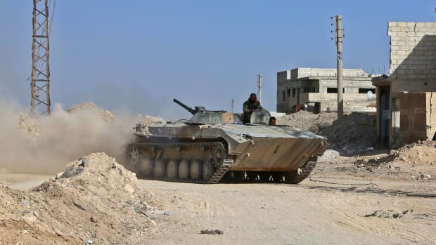A Syrian army APC rolls in the former rebel-held area of Beit Nayem in the Eastern Ghouta region on the outskirts of the capital Damascus.