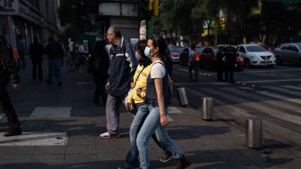 Two women wear face masks on May 16th, 2019, in Mexico City, Mexico. Mexico City's air pollution has worsened as a consequence of high temperatures, lack of rain, and fires located around the city's valley, where people have been advised to stay indoors and avoid using their vehicles, and schools have been ordered to close.