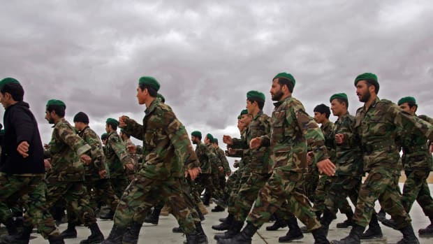 Afghan Army soldiers march to a briefing at Camp Shorabak in Afghanistan's Helmand province.