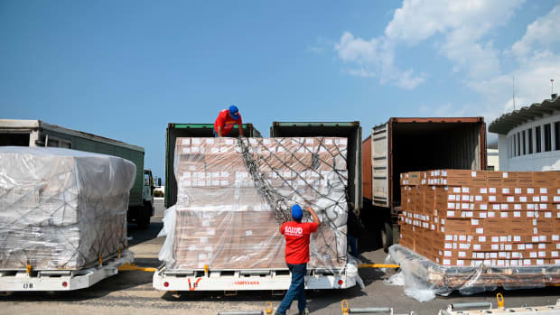 Workers unload medicines and disposable medical supplies from a Chinese Yangtze River Express Airlines Boeing 747 cargo plane after landing at Simon Bolivar International Airport on May 16th, 2019, in Maiquetia, Venezuela.