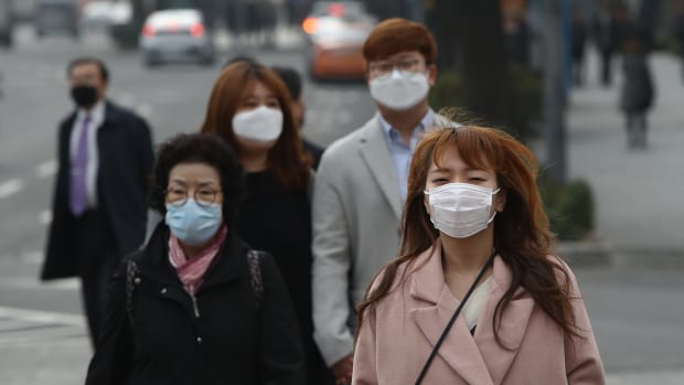Pedestrians wearing masks walk during a polluted day in Seoul, South Korea.